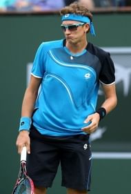 Denis Istomin reacts to a shot from Roger Federer at the BNP Paribas Open at Indian Wells on March 9, 2013